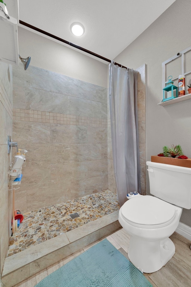 full bath with a stall shower and toilet
