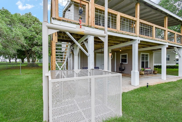 exterior space featuring a yard, a patio, fence, and stairs