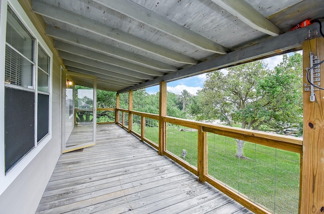 wooden deck featuring a lawn