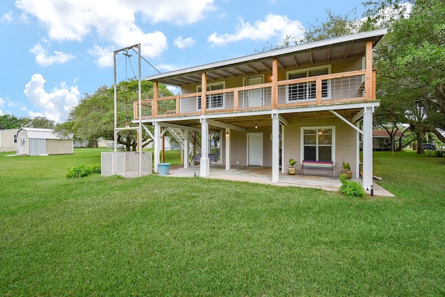 back of property featuring a lawn, a deck, a patio area, stairway, and an outdoor structure