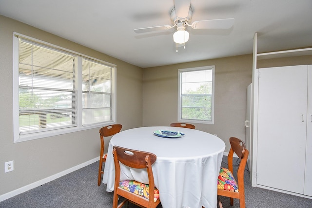 carpeted dining room with baseboards and ceiling fan