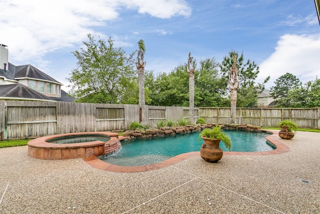 view of pool featuring a fenced backyard, a patio, and a pool with connected hot tub