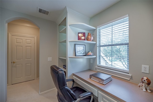 home office featuring arched walkways, light carpet, and visible vents