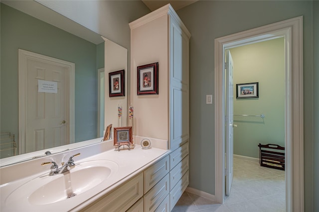 bathroom with vanity, baseboards, and tile patterned flooring