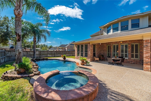 view of pool with a patio, a pool with connected hot tub, and a fenced backyard