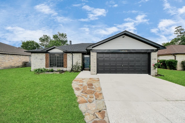 16926 Hummingbird, Conroe, TX 77385 - single story home with driveway, a garage, brick siding, central AC, and a front lawn