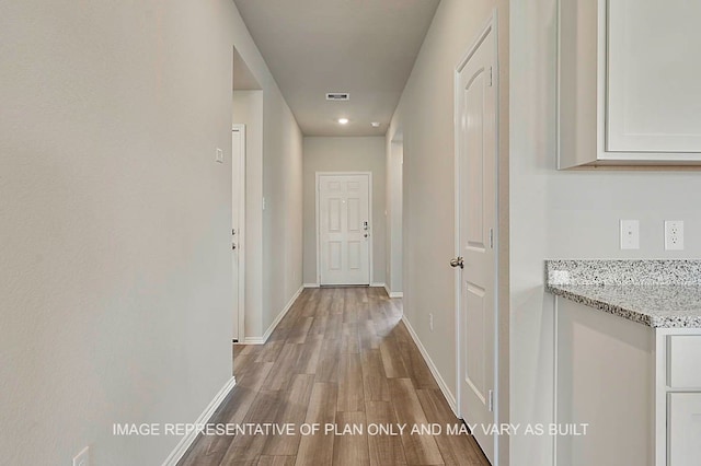 hall with baseboards, recessed lighting, wood finished floors, and visible vents