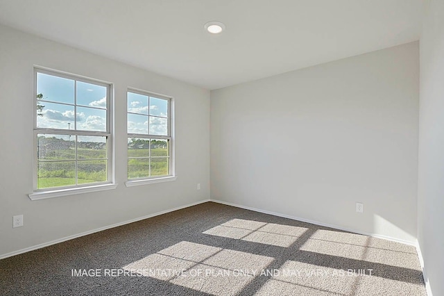 spare room featuring baseboards, recessed lighting, and carpet floors