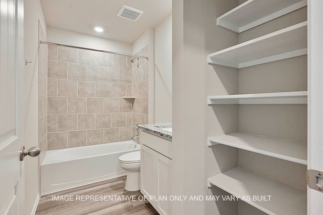 bathroom with washtub / shower combination, toilet, recessed lighting, wood finished floors, and visible vents
