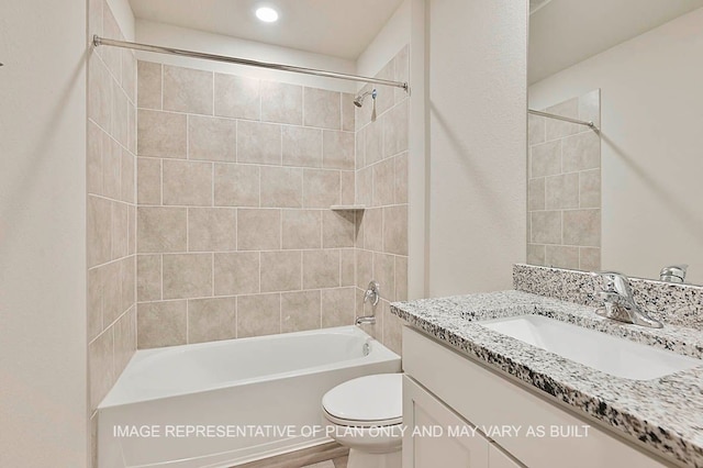 bathroom featuring shower / bath combination, vanity, and toilet