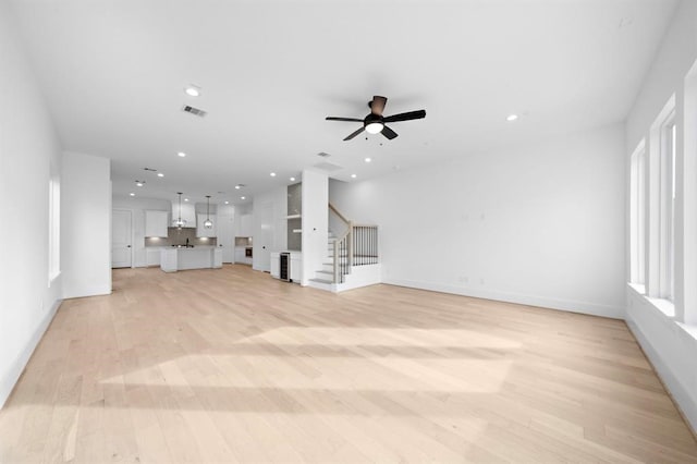 1430 Nashua St, Houston, TX 77008 - unfurnished living room featuring recessed lighting, visible vents, stairway, and light wood-type flooring