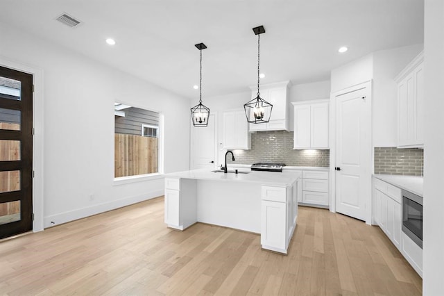 1430 Nashua St, Houston, TX 77008 - kitchen with light countertops, decorative backsplash, custom range hood, and visible vents