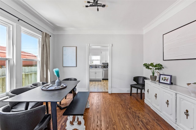 dining room with baseboards, ornamental molding, dark wood-style flooring, and a wealth of natural light