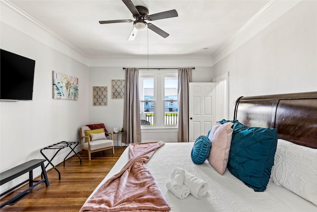 bedroom with crown molding, ceiling fan, and wood finished floors