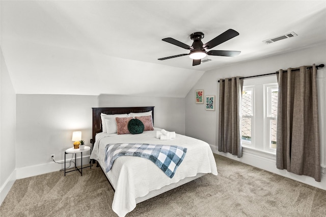 bedroom featuring carpet flooring, a ceiling fan, baseboards, vaulted ceiling, and visible vents