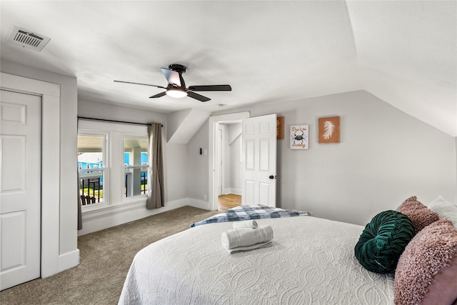 carpeted bedroom with baseboards, a ceiling fan, lofted ceiling, and visible vents