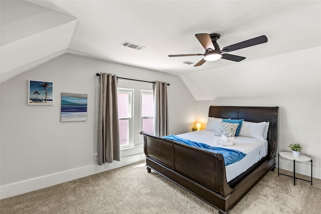 carpeted bedroom featuring a ceiling fan, baseboards, visible vents, and vaulted ceiling