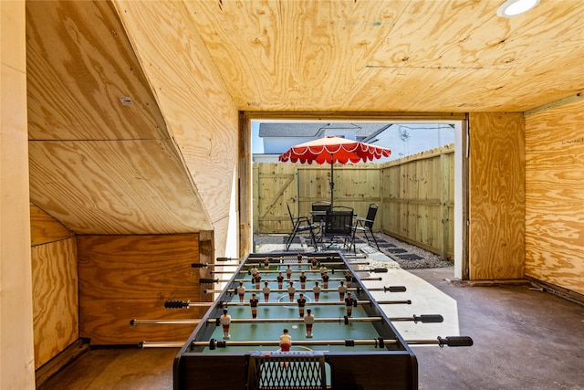 game room with wood walls and wooden ceiling