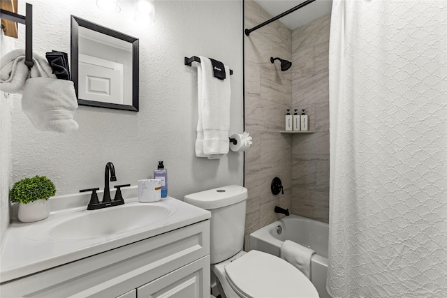 full bathroom with vanity, a textured wall, toilet, and shower / tub combo