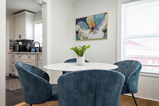 dining space featuring a healthy amount of sunlight and wood finished floors