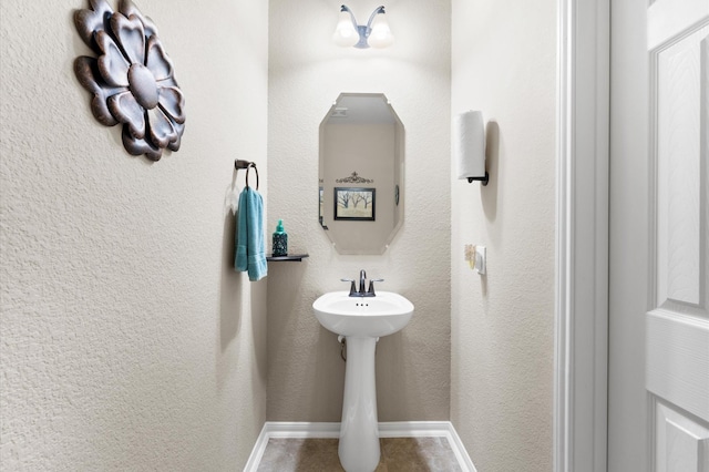 bathroom with baseboards
