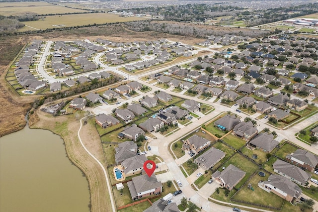 drone / aerial view featuring a water view and a residential view