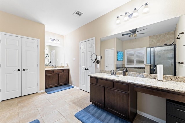bathroom featuring a sink, a ceiling fan, a stall shower, and tile patterned floors