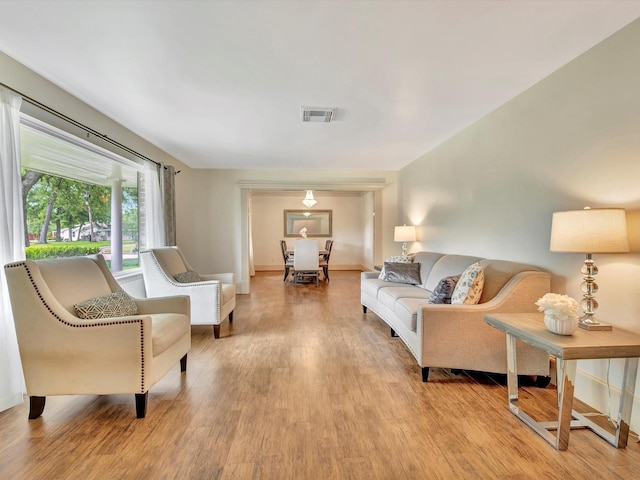 living area with light wood-style flooring and baseboards