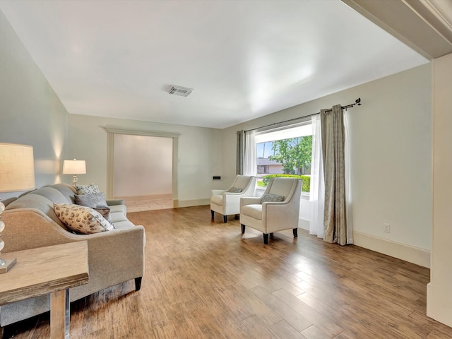 living area with wood finished floors and baseboards