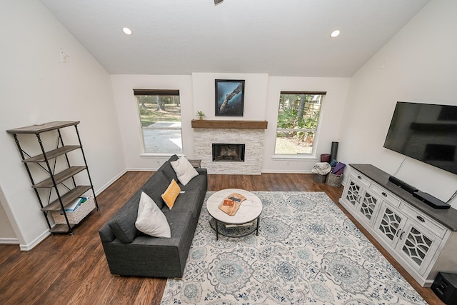living area featuring a fireplace, vaulted ceiling, wood finished floors, baseboards, and recessed lighting