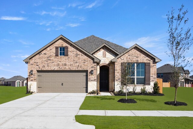 2219 Inglenook Grove Dr, Katy, TX 77493 - french country inspired facade with brick siding, driveway, a front lawn, stone siding, and roof with shingles