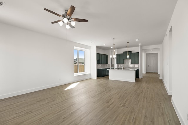 2219 Inglenook Grove Dr, Katy, TX 77493 - unfurnished living room featuring light wood-style floors, recessed lighting, baseboards, and a ceiling fan