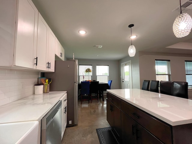 kitchen with visible vents, stainless steel dishwasher, white cabinets, concrete floors, and recessed lighting