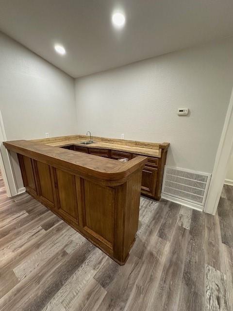 bar featuring recessed lighting, visible vents, a sink, and dark wood-type flooring