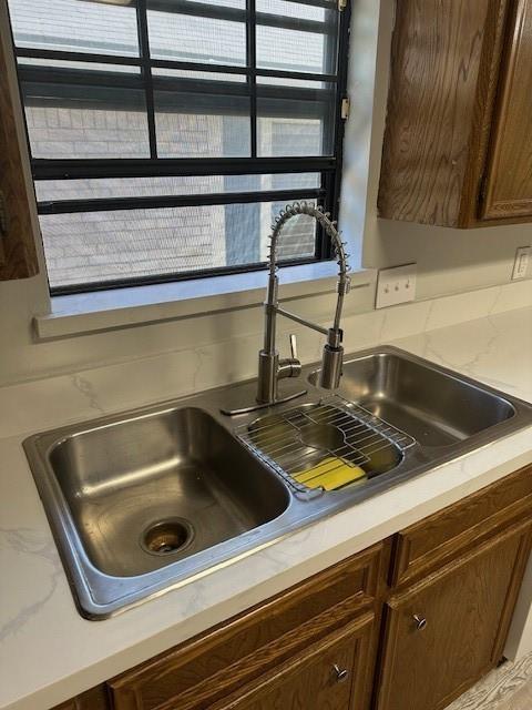 room details featuring a sink and dark brown cabinets