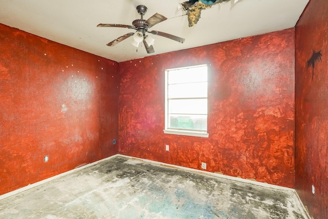 empty room featuring baseboards and a ceiling fan