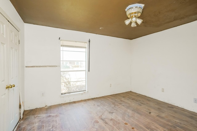 spare room with ceiling fan and wood finished floors