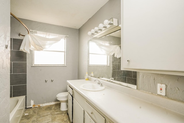 bathroom with vanity, bathing tub / shower combination, and toilet