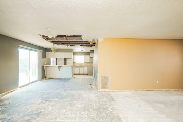 unfurnished living room with visible vents