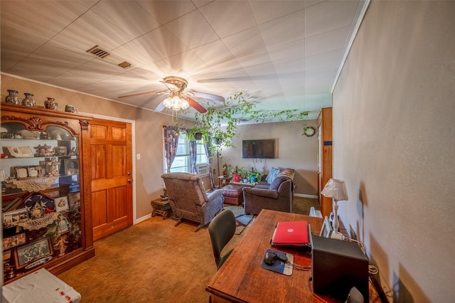 home office with a ceiling fan, baseboards, visible vents, and carpet