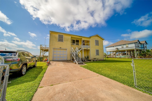 view of front facade with stairway, an attached garage, concrete driveway, and a front lawn