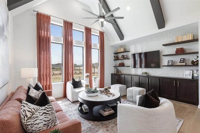 17703 Monarch Vista Ln, Conroe, TX 77302 - living room with ceiling fan, beam ceiling, light wood-style floors, and high vaulted ceiling