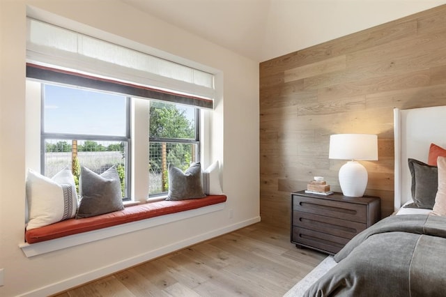 17703 Monarch Vista Ln, Conroe, TX 77302 - bedroom with wood walls and light wood-style floors