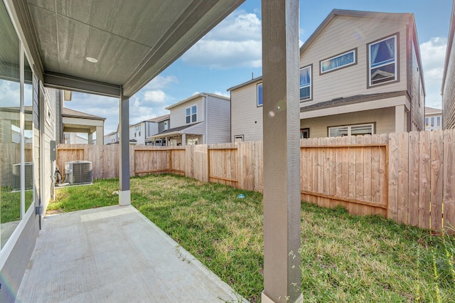 view of yard featuring a fenced backyard, a patio, and cooling unit