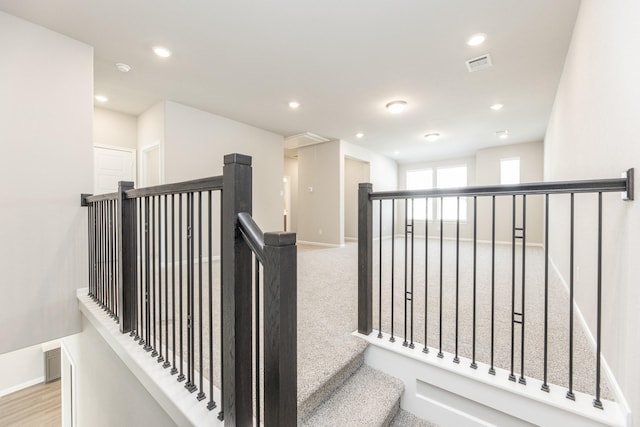 stairway featuring recessed lighting, baseboards, visible vents, and carpet