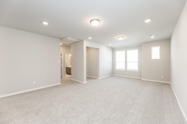 interior space with baseboards, visible vents, recessed lighting, and light colored carpet
