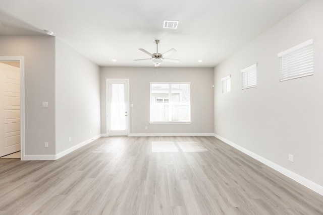 unfurnished living room featuring baseboards, ceiling fan, light wood-style flooring, and visible vents