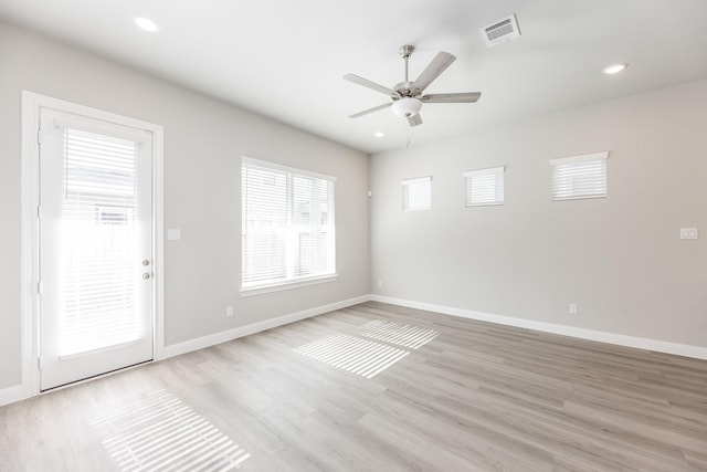 empty room featuring visible vents, baseboards, recessed lighting, light wood-type flooring, and a ceiling fan