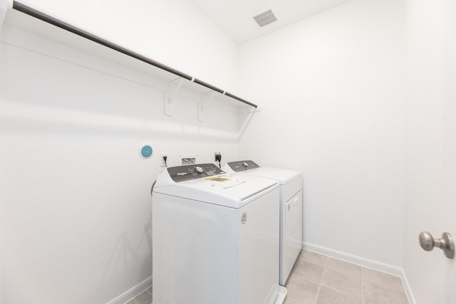 3011 Valley Peak Dr, Houston, TX 77063 - clothes washing area featuring laundry area, visible vents, light tile patterned floors, baseboards, and washer and dryer