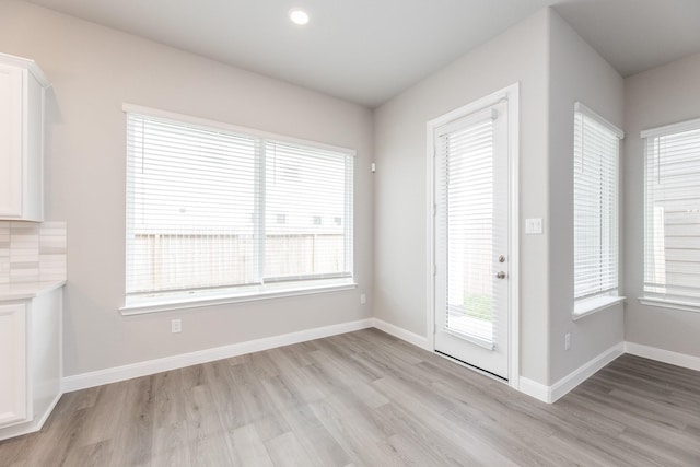 3011 Valley Peak Dr, Houston, TX 77063 - unfurnished dining area featuring baseboards and light wood finished floors